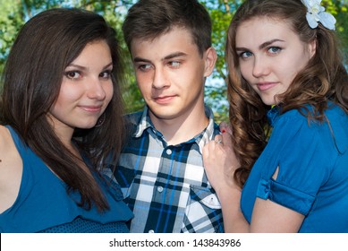 Two Teenage Girls Looking In Love On One Guy Outdoor Closeup