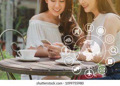 Two teenage women use smartphone with technology icon, internet of things conceptual