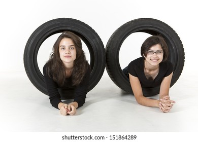 Two Teenagers Are Climbing Through Tires