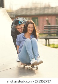 Two Teenagers Having Fun With Skateboard In The Skate Park