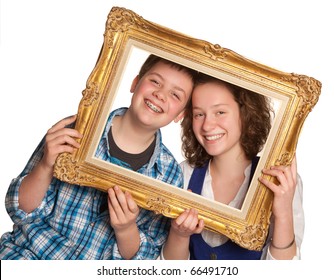 Two Teenagers Posing Holding A Picture Frame