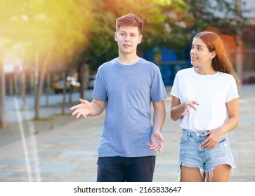 Two Teenagers Are Talking About Play On Walk On The Street