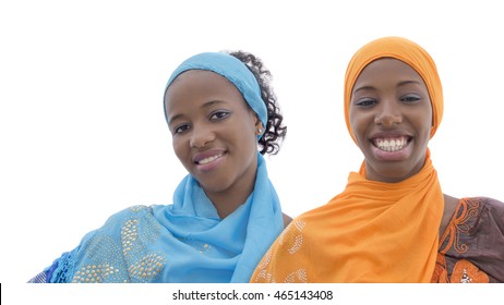 Two teenagers wearing embroidered dresses and headscarves, isolated