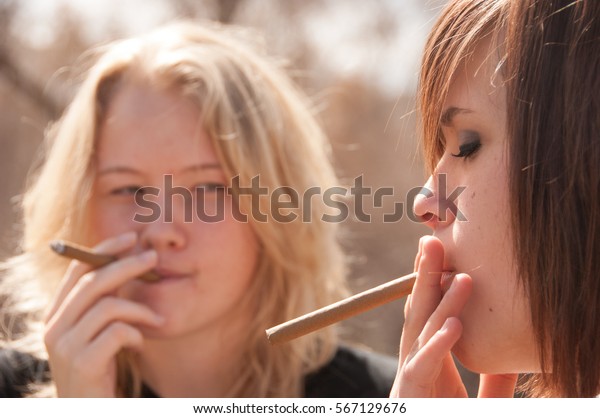 Two Teens Smoking Cigars Outside Girl Stock Photo (Edit Now) 567129676