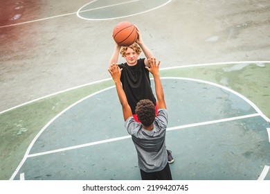 The Two Teens In Sportswear Playing Basketball Game