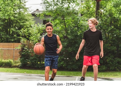 The Two Teens In Sportswear Playing Basketball Game