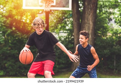 The Two Teens In Sportswear Playing Basketball Game