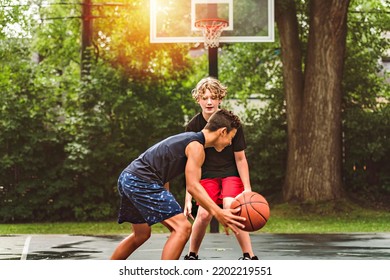 The Two Teens In Sportswear Playing Basketball Game