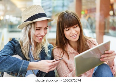 Two Teens Use Tablet For Price Comparison And Online Shopping