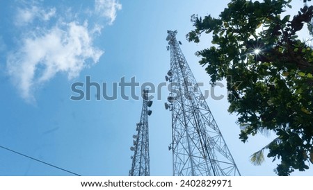 two Telecommunication towers and satellite dish telecommunication network on blue sky