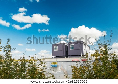 Two, temporary construction offices seen on a housing development site in the UK. The offices are staffed by architects and engineers for the housing development which is in progress.