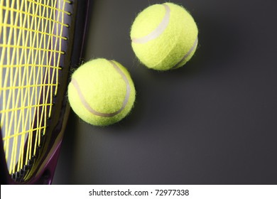 Two tennis balls and a racquet.