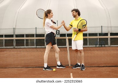 Two tennis players shaking hands at tennis court before the match - Powered by Shutterstock