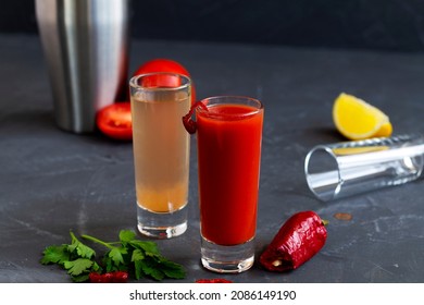 two tequila shots on black background. Sangrita is Mexican traditional alcohol drink with tequila, tomato juice, hot spices, chili pepper and lime.copy space.alcoholic drink. vodka