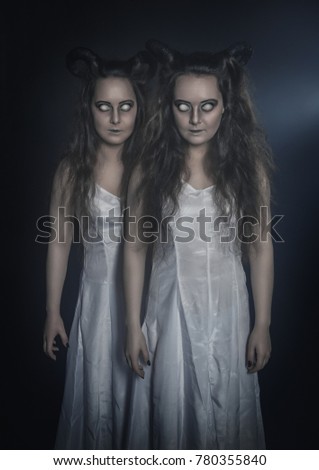 Two terrible ghost with horns on dark background