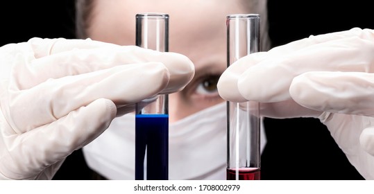 two test tubes, with a blue and red liquid in the hand of a girl in the background. Close up. research or development of the covid coronavirus vaccine 19. Long layout