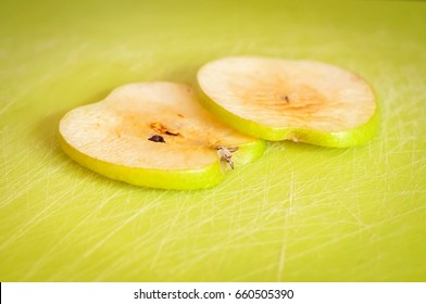 Two Thin Green Apple Slices On A Cutting Board Turned Brown Due To The Oxidation Process Close Up Stock Image.