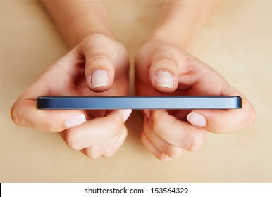 Two thumbs of female hands typing on a smartphone - Powered by Shutterstock