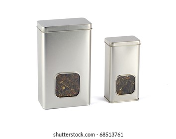 Two tins with small windows for tea.