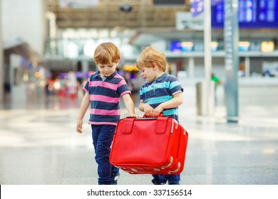 Two Tired Little Sibling Kids Boys At The Airport, Traveling Together. Angry Family, Twins Children Waiting. Canceled Flight Due To Pilot Strike.