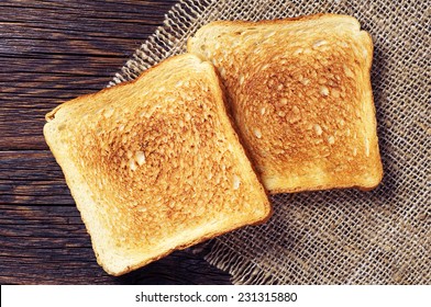 Two Toast Bread On Wooden Background Closeup. Top View