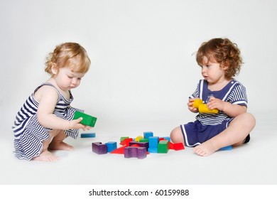 Two Toddler Girls Playing With Building Blocks