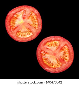 Two Tomato Sliced Isolated On Black