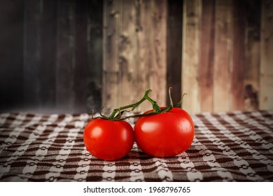 Two tomatoes on the table