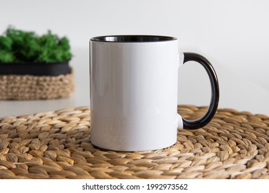 Two tone black and white mug mockup for presentation sublimation designs. Stock photos of white coffee mug ont he table with minimalist decoration for designers - Shutterstock ID 1992973562