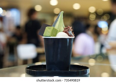 Two Tone Soft Serve Ice Cream, Green Tea And Charcoal Served In Black Cup Decorated With Mochi Ball, Chocolate And Red Bean, Traditional Japanese Confectionery, Healthy Concept.