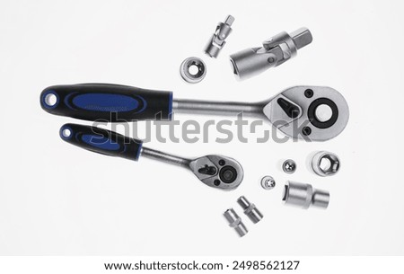 Two torque wrenches and nuts on white, flat lay. Auto mechanic tools