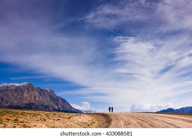 Two Tourists Are Confident Of The Chosen Path In The Mountains