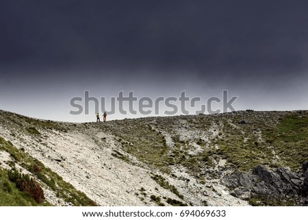 Similar – Image, Stock Photo Four people standing in a row on a ridge (2/2)