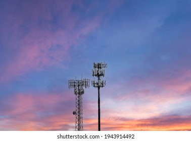 Two Towers Providing Cellular Broadband And Data Service To Rural Areas Against The Sunset. Illustrates Digital Divide.