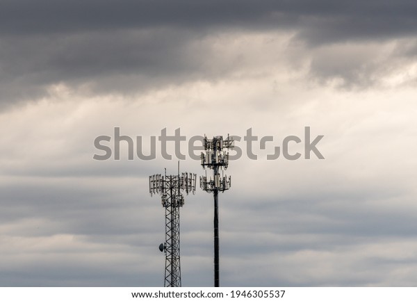 Two towers\
providing cellular broadband and data service to rural areas on\
stormy day. Illustrates digital\
divide.