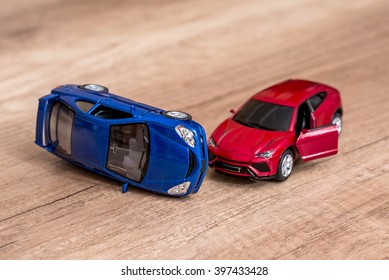 Two Toy Cars On Desk