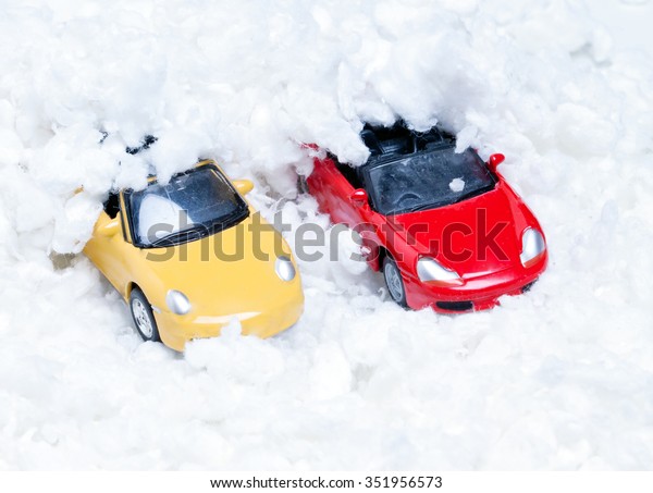 two toy cars\
strewn with artificial\
snow.Closeup