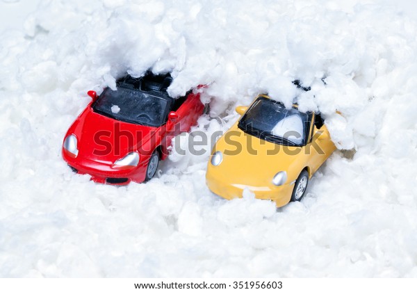 two toy cars\
strewn with artificial\
snow.Closeup