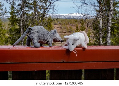 Two Toy Mice On A Red Bannister In The Mountains