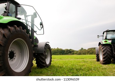 two tractors on the green field - Powered by Shutterstock