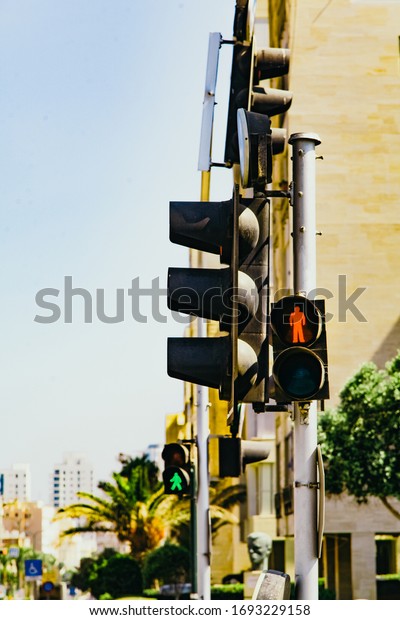 two traffic lights at a pedestrian crossing against\
each other