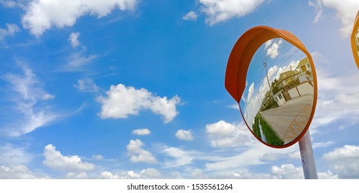 two Traffic mirrors ( Safety convex mirror ) with blue sky and white clouds at intersection or curve of road, safety and security concept, close up - Powered by Shutterstock