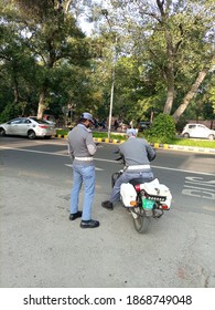 Two Traffic Wardens Are Watching Over The Traffic On Mall Road - Lahore Pakistan - Dec 2020