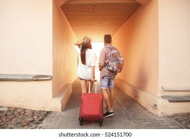 Two travelers on vacation walking around the city with luggage - Powered by Shutterstock