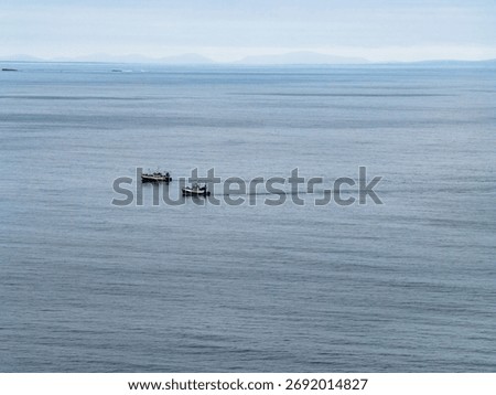 Two trawler pulling one big net to catch sprat in Donegal Bay within the six nautical mile zone, Ireland