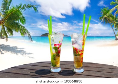 Two Tropical Cocktails On The Beach Table For The Perfect Summer Vacation