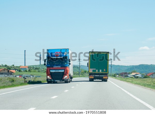 Two trucks carrying goods, in\
traffic, pass each other.Romania, Severin. May, 07,\
2021