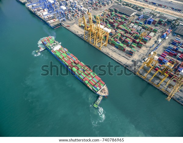 two tug boat towing cargo container in warehouse harbor
at thailand .