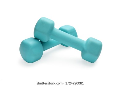 Two turquoise colored rubber dumbbells lying at white table close-up - Shutterstock ID 1724920081