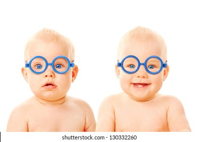 Two twins babies boys wearing glasses. One kid serious, the other child smiling. Young students. Isolated on white background - Shutterstock ID 130332260